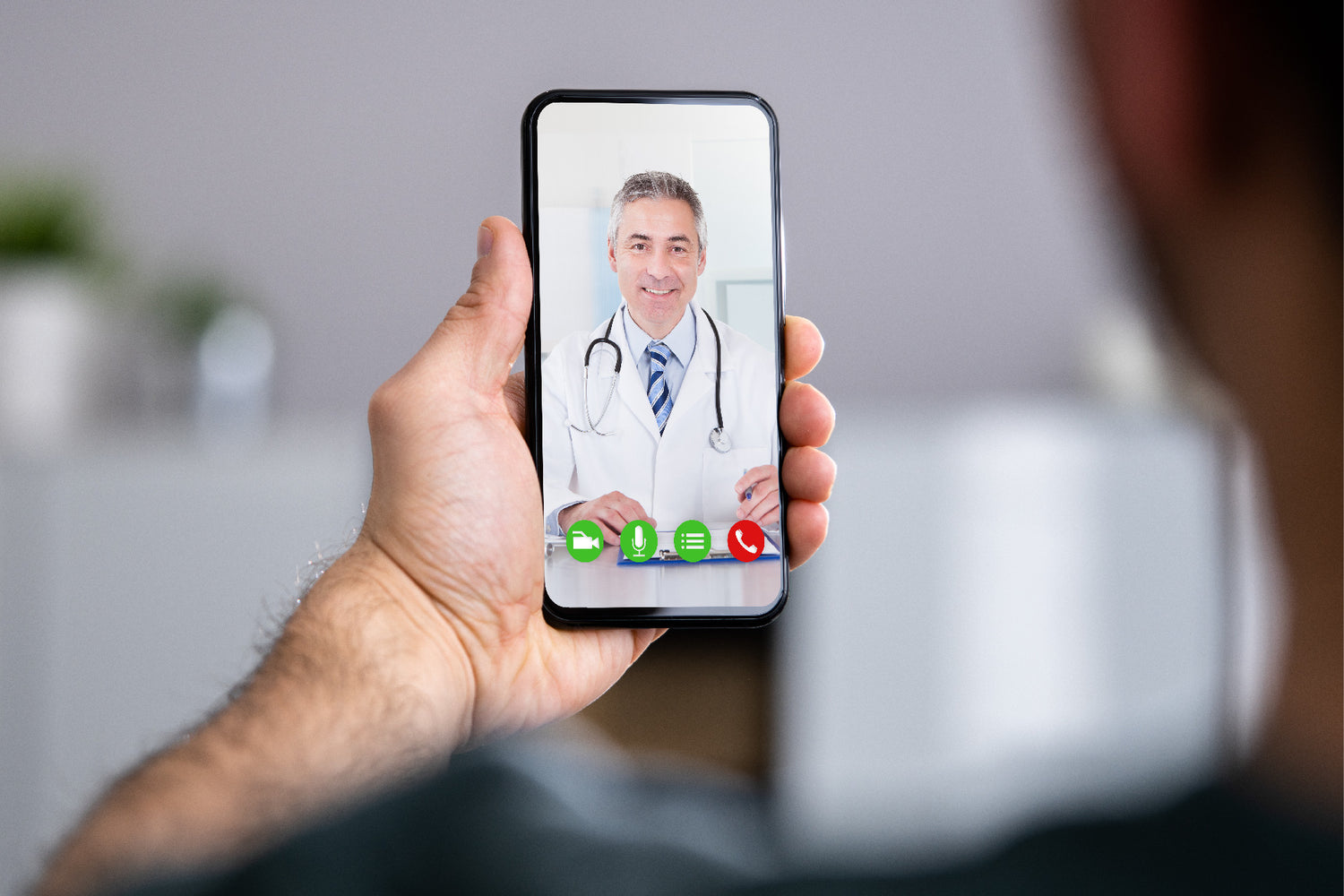 Doctor talking patient on smartphone for patient data collection.